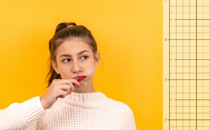 Women brushing her teeth beside dentist posture assessment wall grid