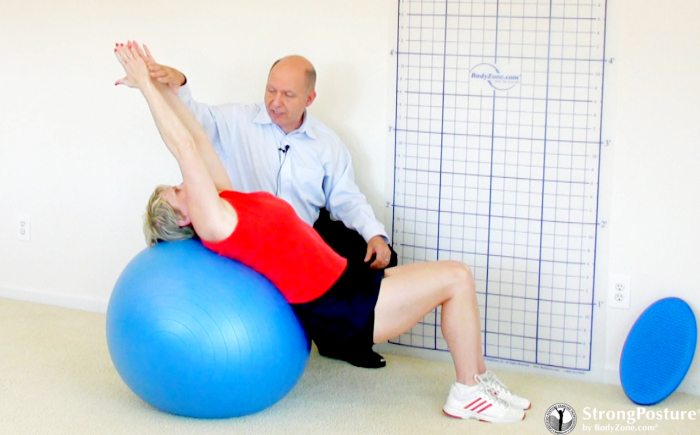 posture expert steven weiniger helping a woman do a strongposture exercise on a ball